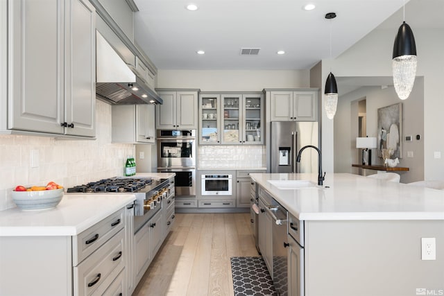 8956 Suncreek Trl, Reno, NV 89523 - kitchen featuring stainless steel appliances, light countertops, tasteful backsplash, a center island with sink, and recessed lighting