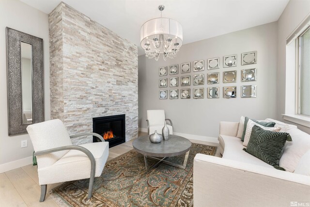 8956 Suncreek Trl, Reno, NV 89523 - living room with a stone fireplace, wood finished floors, and a chandelier