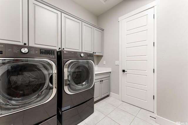 8956 Suncreek Trl, Reno, NV 89523 - laundry area featuring cabinet space, washing machine and dryer, and light tile patterned floors
