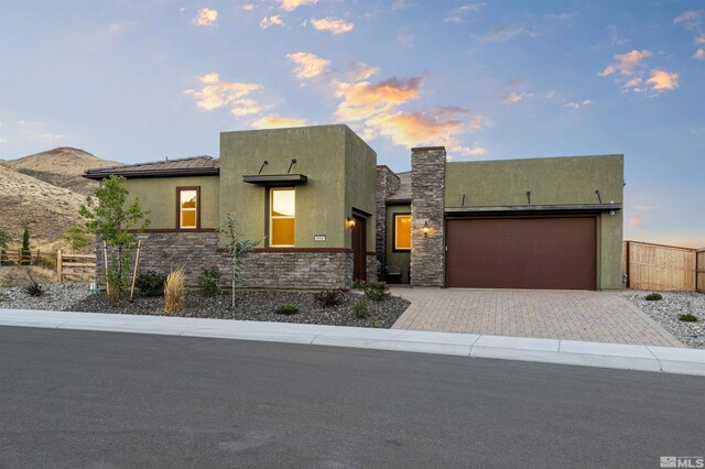 8956 Suncreek Trl, Reno, NV 89523 - view of front of property with an attached garage, stucco siding, driveway, and stone siding