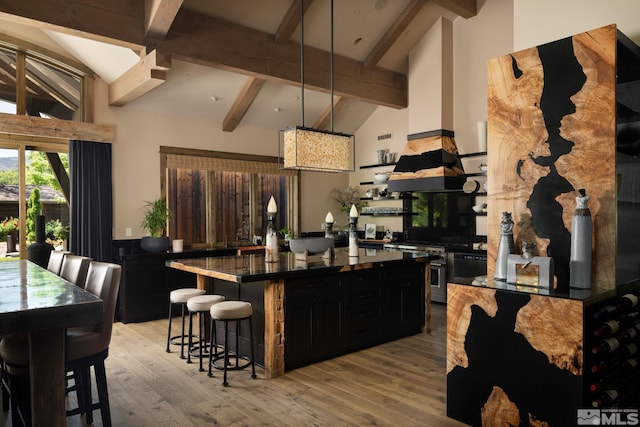 4000 Goodsell Ln, Reno, NV 89523 - kitchen with dark countertops, a breakfast bar area, beamed ceiling, dark cabinetry, and a kitchen island