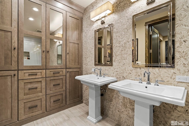 4000 Goodsell Ln, Reno, NV 89523 - bathroom with wood finished floors, two sinks, wallpapered walls, and recessed lighting