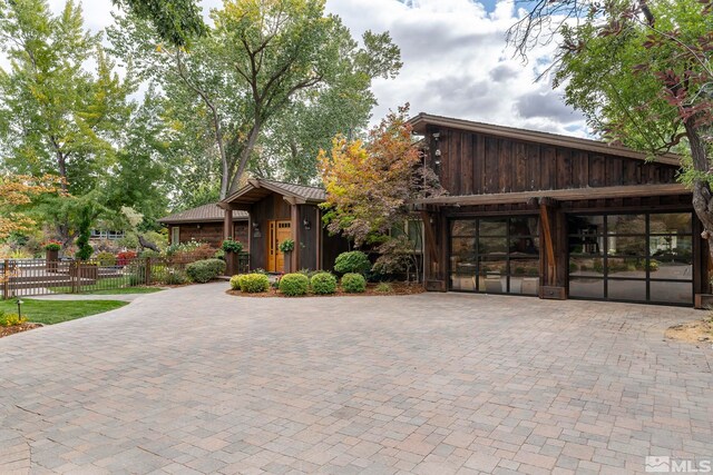 4000 Goodsell Ln, Reno, NV 89523 - view of front of home with fence, curved driveway, and board and batten siding