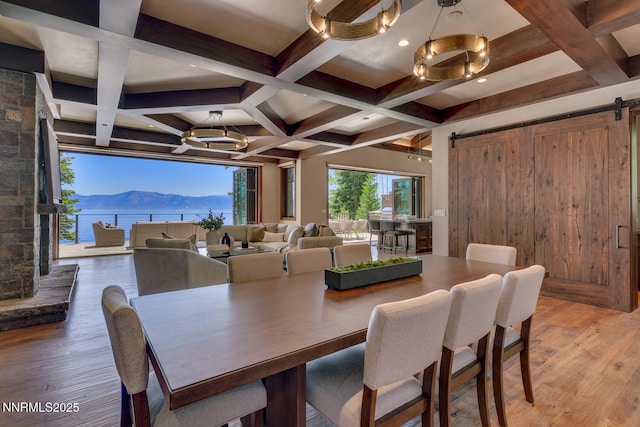 4250 N Lake Blvd, Carnelian Bay, CA 96140 - dining room with a barn door, a chandelier, a mountain view, light wood-style flooring, and beamed ceiling