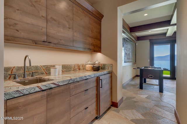 4250 N Lake Blvd, Carnelian Bay, CA 96140 - kitchen with stone tile floors, beamed ceiling, modern cabinets, recessed lighting, and brown cabinets
