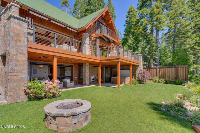 4250 N Lake Blvd, Carnelian Bay, CA 96140 - back of house with a balcony, a hot tub, a patio, an outdoor living space with a fire pit, and stone siding