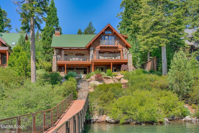 4250 N Lake Blvd, Carnelian Bay, CA 96140 - rear view of house featuring a chimney and a deck with water view