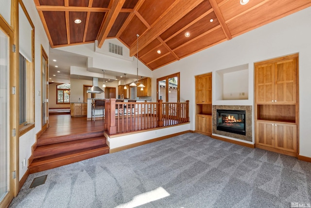 210 Sheridan Creek Ct, Gardnerville, NV 89460 - unfurnished living room featuring a glass covered fireplace, recessed lighting, baseboards, carpet, and wood ceiling