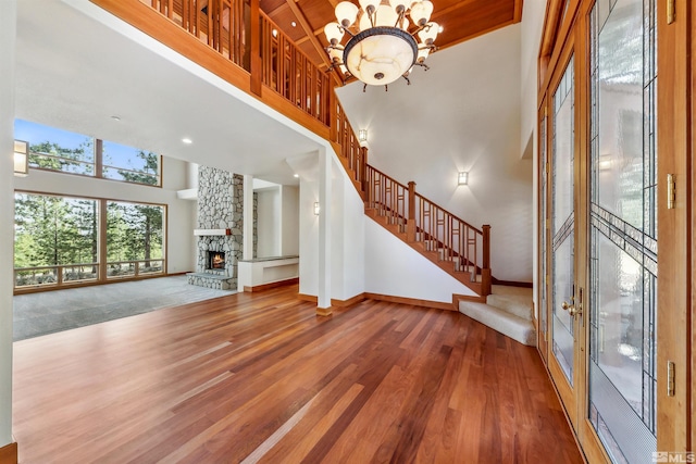 210 Sheridan Creek Ct, Gardnerville, NV 89460 - unfurnished living room with a towering ceiling, stairs, wood finished floors, baseboards, and a chandelier