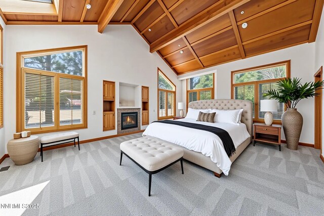 210 Sheridan Creek Ct, Gardnerville, NV 89460 - bedroom with light carpet, baseboards, beam ceiling, high vaulted ceiling, and a glass covered fireplace
