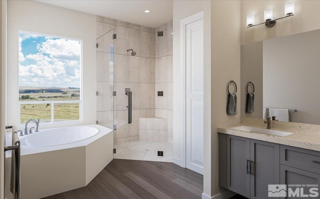 1223 Golden Eagle Ct, Gardnerville, NV 89410 - full bathroom featuring a shower stall, a bath, wood finished floors, vanity, and recessed lighting