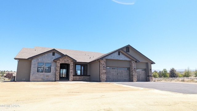 1223 Golden Eagle Ct, Gardnerville, NV 89410 - view of front facade featuring stone siding, asphalt driveway, an attached garage, and roof with shingles