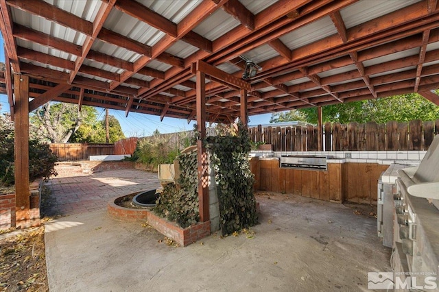 1600 Duke Way, Reno, NV 89502 - fenced backyard with a patio area and an outdoor kitchen