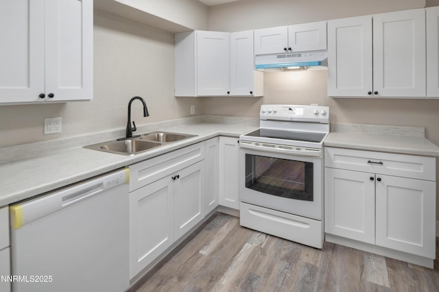 1600 Duke Way, Reno, NV 89502 - kitchen featuring white appliances, a sink, under cabinet range hood, white cabinetry, and light countertops
