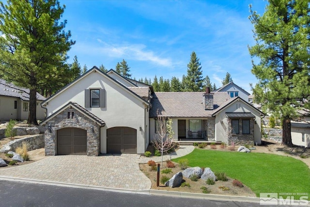 20765 Parc Foret Dr, Reno, NV 89511 - view of front facade with stone siding, stucco siding, a front yard, and decorative driveway