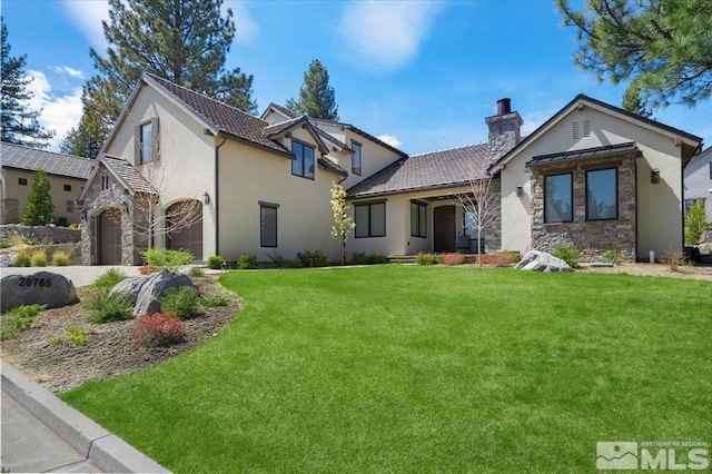 20765 Parc Foret Dr, Reno, NV 89511 - view of front of house featuring stone siding, a chimney, stucco siding, a front yard, and driveway