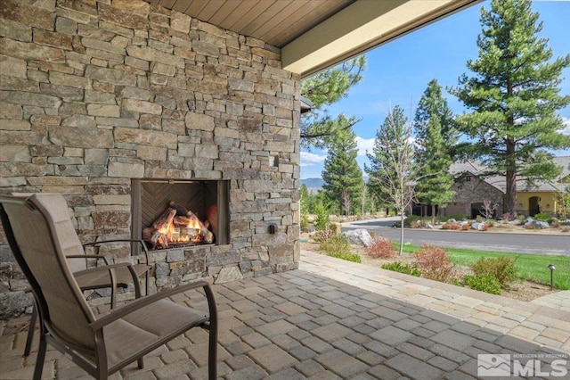 20765 Parc Foret Dr, Reno, NV 89511 - view of patio / terrace with an outdoor stone fireplace