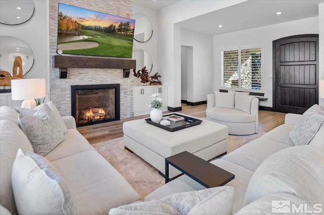 20765 Parc Foret Dr, Reno, NV 89511 - living area featuring wood finished floors, a stone fireplace, and recessed lighting