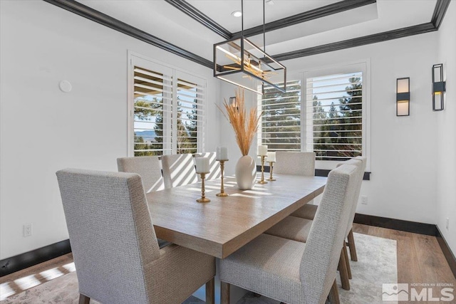 20765 Parc Foret Dr, Reno, NV 89511 - dining space with a chandelier, ornamental molding, wood finished floors, baseboards, and a tray ceiling