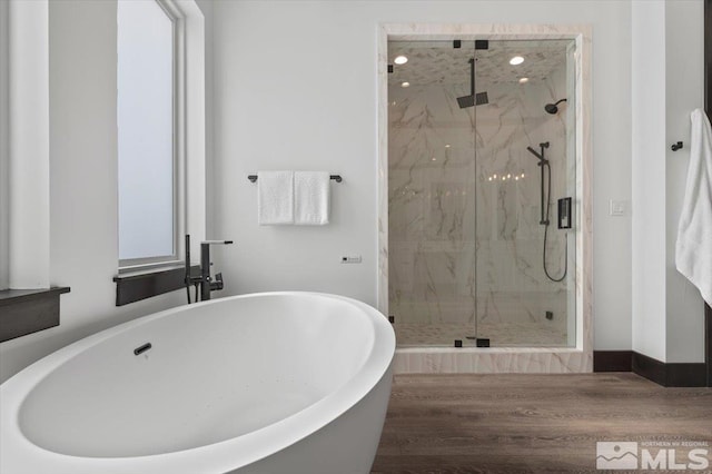20765 Parc Foret Dr, Reno, NV 89511 - bathroom featuring a marble finish shower, a freestanding tub, and wood finished floors