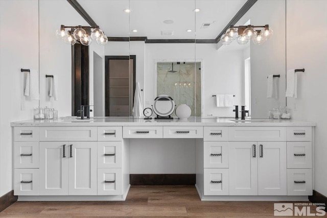 20765 Parc Foret Dr, Reno, NV 89511 - full bathroom featuring a shower stall, wood finished floors, vanity, and crown molding