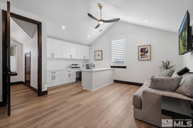 20765 Parc Foret Dr, Reno, NV 89511 - kitchen featuring lofted ceiling, ceiling fan, baseboards, white cabinetry, and light wood-style flooring