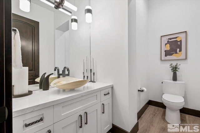 20765 Parc Foret Dr, Reno, NV 89511 - bathroom with toilet, wood finished floors, vanity, and baseboards