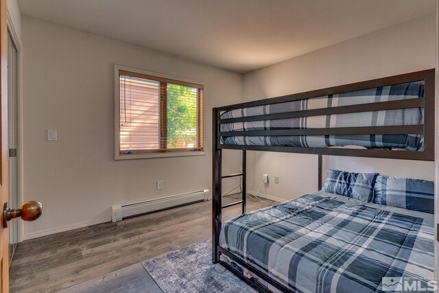 931 Incline Way Unit 249Mccloud, Incline Village, NV 89451 - bedroom featuring a baseboard heating unit, wood finished floors, and baseboards