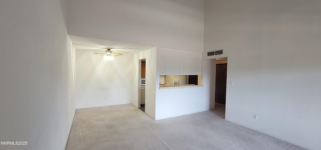 2845 Idlewild Dr Unit 303, Reno, NV 89509 - spare room with light carpet, a ceiling fan, and a high ceiling