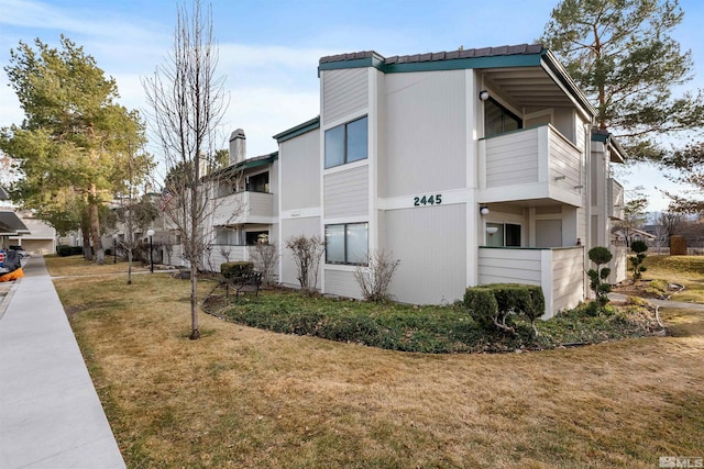 2445 Sycamore Glen Dr Unit 6, Sparks, NV 89434 - view of side of home featuring a chimney and a yard