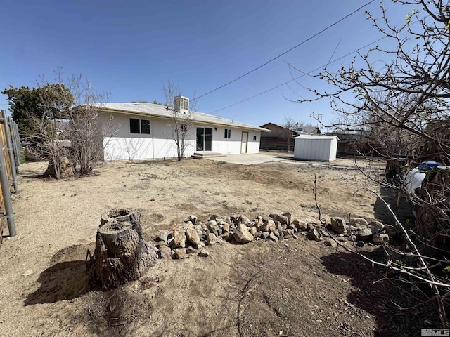 309 M St, Hawthorne, NV 89415 - rear view of property with a storage unit, an outbuilding, a patio, and central air condition unit