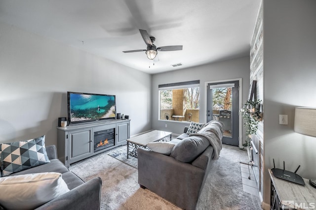 900 S Meadows Pkwy Unit 3522, Reno, NV 89521 - living room featuring a lit fireplace, light colored carpet, and ceiling fan