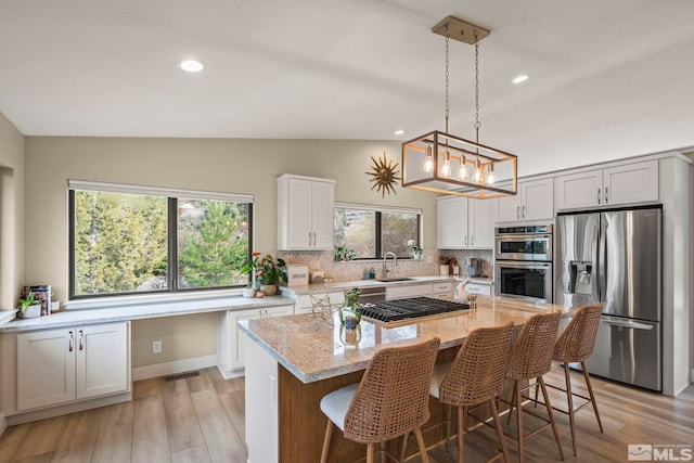 4400 Bridle Way, Reno, NV 89519 - kitchen featuring stainless steel appliances, a sink, light stone countertops, tasteful backsplash, and recessed lighting