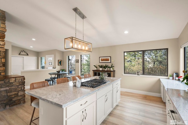 4400 Bridle Way, Reno, NV 89519 - kitchen featuring stainless steel gas stovetop, a kitchen bar, plenty of natural light, white cabinetry, and recessed lighting
