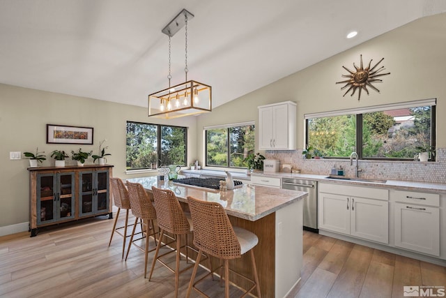 4400 Bridle Way, Reno, NV 89519 - kitchen with a sink, appliances with stainless steel finishes, lofted ceiling, light stone counters, and healthy amount of natural light