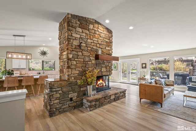 4400 Bridle Way, Reno, NV 89519 - living room featuring a fireplace, light wood-style flooring, lofted ceiling, and recessed lighting