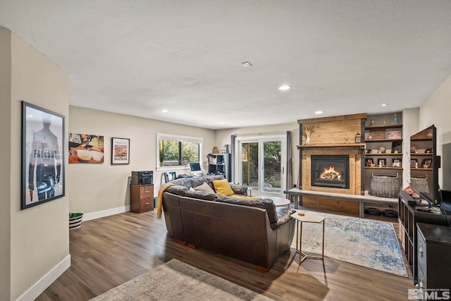 4400 Bridle Way, Reno, NV 89519 - living room featuring baseboards, wood finished floors, a fireplace, recessed lighting, and a textured ceiling