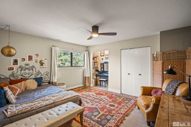 4400 Bridle Way, Reno, NV 89519 - bedroom with baseboards, a textured ceiling, a closet, and a ceiling fan