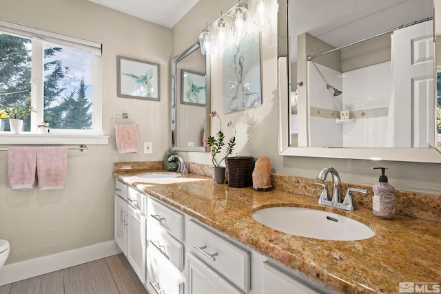 4400 Bridle Way, Reno, NV 89519 - full bathroom featuring toilet, double vanity, a shower, and baseboards
