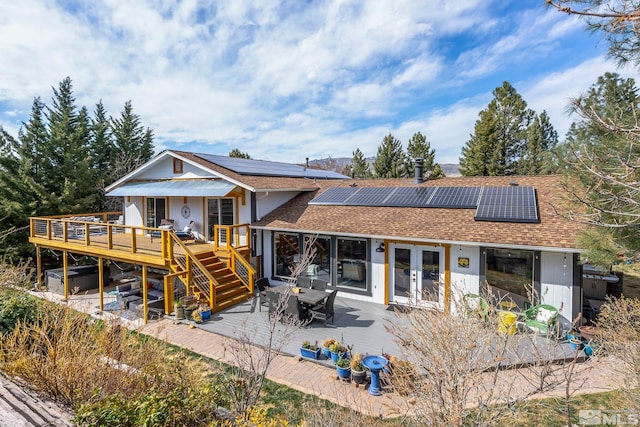 4400 Bridle Way, Reno, NV 89519 - back of property featuring french doors, a wooden deck, a shingled roof, and solar panels