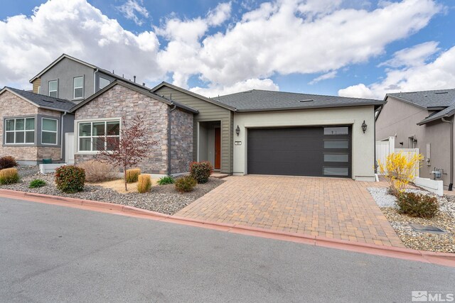 605 Braided Rope Dr, Reno, NV 89511 - view of front of home with a garage, stone siding, driveway, and stucco siding