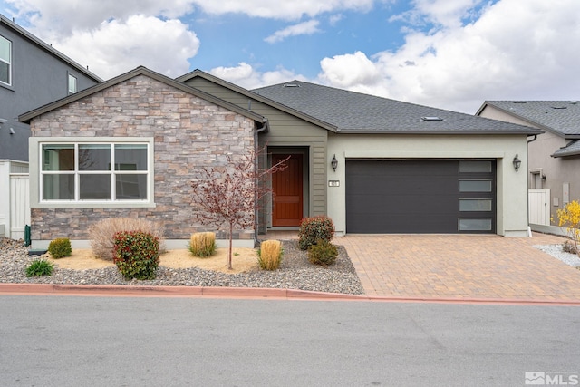 605 Braided Rope Dr, Reno, NV 89511 - view of front of property featuring stone siding, a garage, and decorative driveway