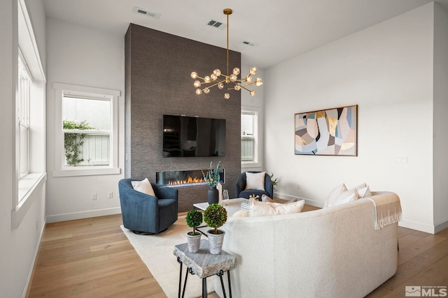 605 Braided Rope Dr, Reno, NV 89511 - living room with light wood-style floors, healthy amount of natural light, baseboards, and a fireplace