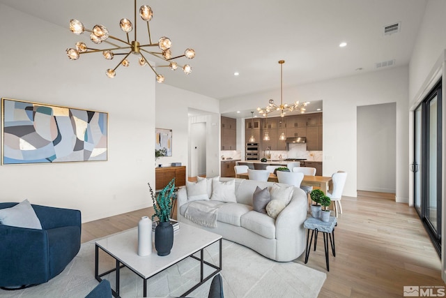 605 Braided Rope Dr, Reno, NV 89511 - living room with a chandelier, light wood finished floors, recessed lighting, and baseboards
