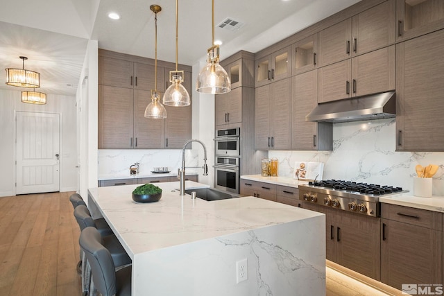 605 Braided Rope Dr, Reno, NV 89511 - kitchen featuring stainless steel appliances, under cabinet range hood, a sink, tasteful backsplash, and recessed lighting