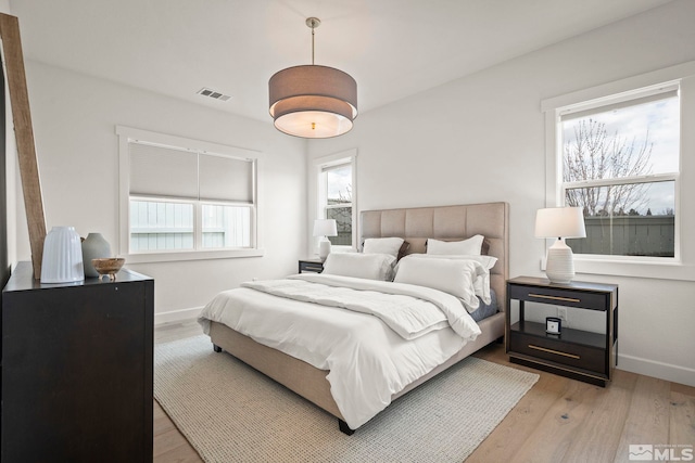 605 Braided Rope Dr, Reno, NV 89511 - bedroom featuring multiple windows, light wood-type flooring, and baseboards