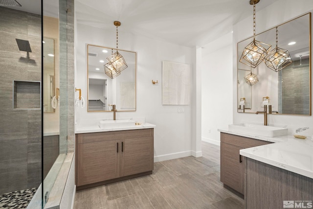 605 Braided Rope Dr, Reno, NV 89511 - bathroom with a tile shower, baseboards, two vanities, wood finished floors, and a chandelier