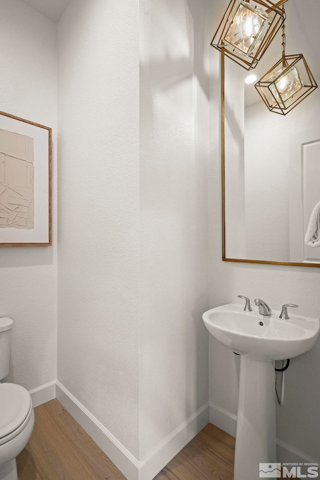 605 Braided Rope Dr, Reno, NV 89511 - half bath featuring wood finished floors, toilet, and baseboards