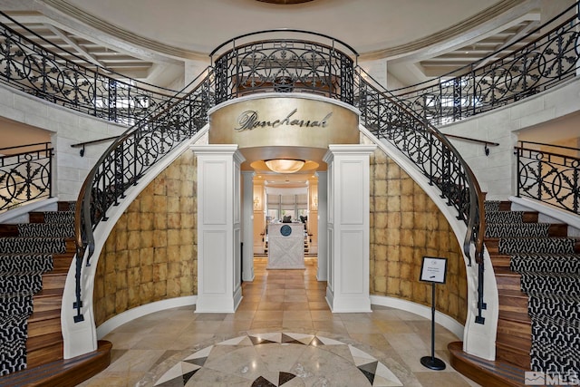 605 Braided Rope Dr, Reno, NV 89511 - foyer featuring inlaid floor details, decorative columns, stairs, arched walkways, and a towering ceiling