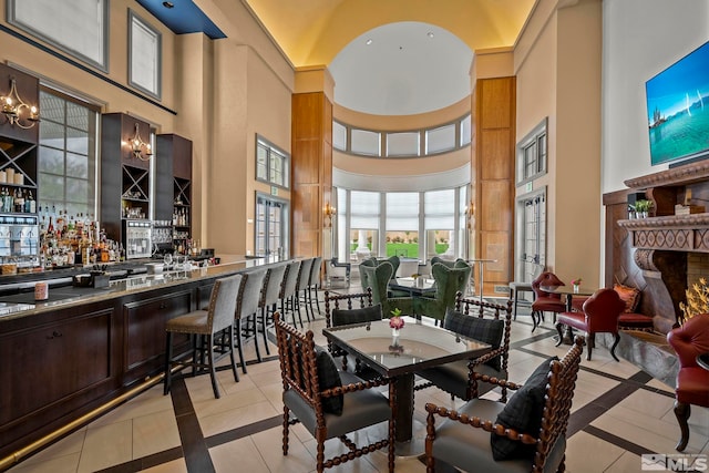 605 Braided Rope Dr, Reno, NV 89511 - dining space with a high ceiling, inlaid floor details, a dry bar, and light tile patterned floors
